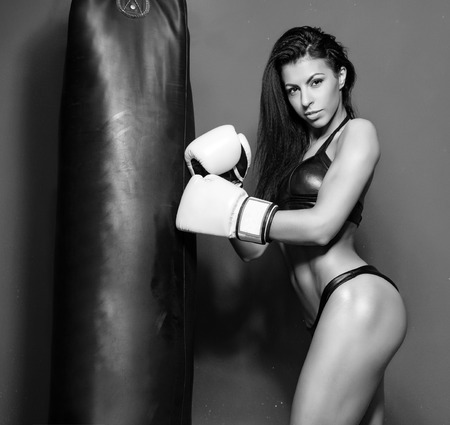 Beautiful sexual boxing girl, fitness, on a red backgroundの写真素材