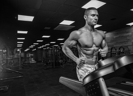 Brutal strong athletic men pumping up muscles workout bodybuilding concept backgroundの写真素材