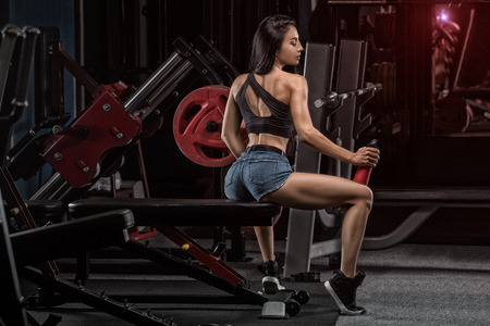 Fitness girl with shaker on a dark backgroundの写真素材