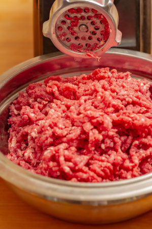 meat and grinder. Minced meat and meat grinder. Meat grinder machine chopping uncooked ground meat.の写真素材