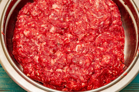 Minced beef close-up in a metal plate. Minced cutlets cooking for dinner. beef, grinder, raw, food