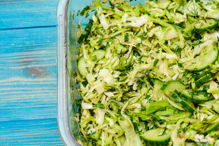 dietary salad from cabbage cucumbers and greens. Salad with cabbage and cucumber and dillの写真素材
