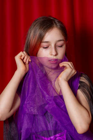 Portrait of a teenage girl in purple with a black dress.の写真素材