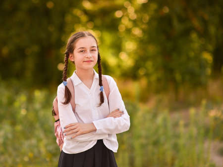 Schoolgirl in nature with a backpack. Back to schoolの写真素材