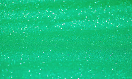 Glitter green soft light focus. Focal and defocus parts of the shine background.の写真素材