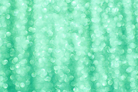 Green glitter soft focus light. Green glitter vintage lights background.の写真素材