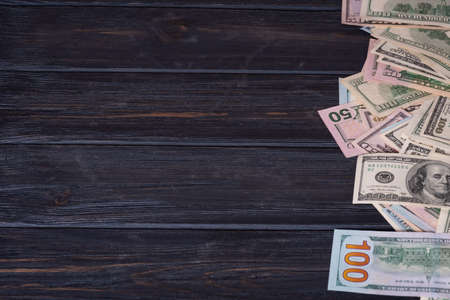 Dollars on a black wood background. Financial savings and income. Banks.の写真素材
