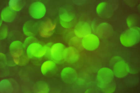 Round shape defocus lights are green. Blurred bokeh. Material for the designer.の写真素材