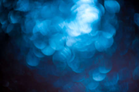 Round shape defocus lights are blue. Blurred bokeh. Material for the designer.の写真素材