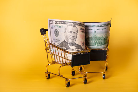 Shopping, discounts. American banknotes dollars in a shopping cart.の写真素材