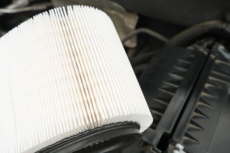 white new fresh Intake air filter, vehicle maintenance, car servicing and repair engine procedure, copy space for textの写真素材
