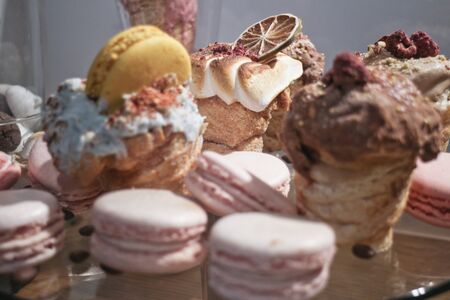 wallpaper from french macaroons, cakes and sweet in cafe, delicious beautiful dessert, soft focus in frontの写真素材