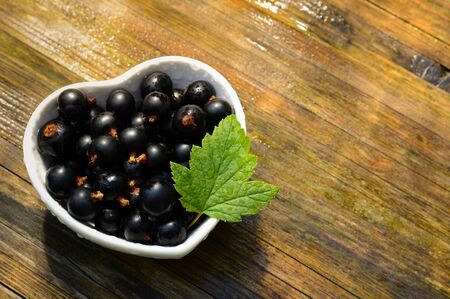 love theme background with heart shaped bowl and blackcurrant after rainの写真素材