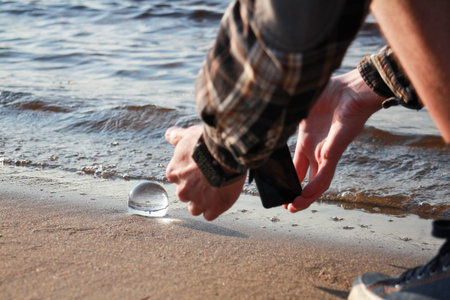 mobile photography, photographer takes a landscape reflection in a crystal ball on a summer evening...