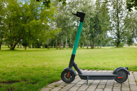 electric scooter - modern eco friendly public and private everyday transport parked on nature...