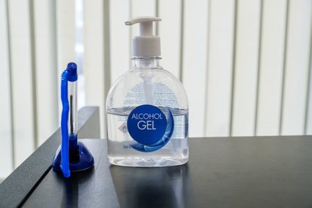 Alcohol gel and at the reception in the salon for hand disinfection. A pen for visitors and salon customers.の写真素材