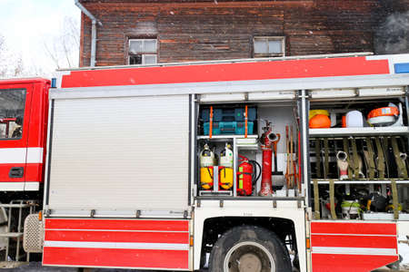 A fire truck with equipment on a city street during an emergency call to extinguish a fire in a house, Riga, Latvia - March 7, 2021.のeditorial素材