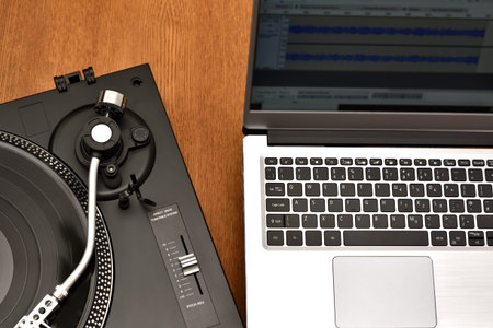 Computer laptop and turntable for digitizing vinyl records. Playing and recording vinyl records on...