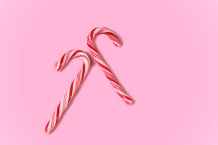 Pair of candy canes on pink backgroundの写真素材