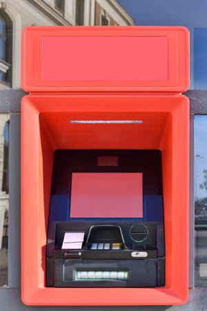ATM machine or cashpoint for financial transactions, deposits and funds transfers with blank red screen and space for textの写真素材