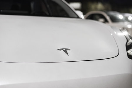 Tesla company logo on the front bonnet of electric car. The insignia of Tesla Motors on a white hood of electric vehicle: Riga, Latvia - September 22, 2021のeditorial素材