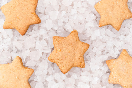 Top view of star shaped Christmas gingerbread cookies on pieces of ice background. Festive Christmas and New Year background.の写真素材