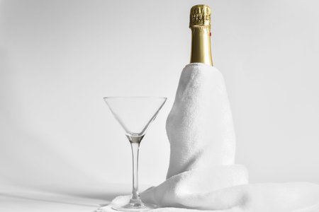 A glass and a bottle of champagne, prepared and served for a festive celebrationの写真素材