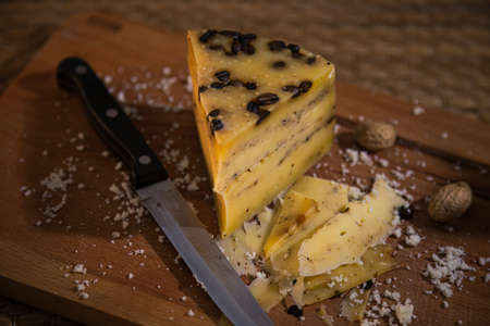 different slicing cheeses Handmade cheese on a wooden board delicious treats foodfotos foodphotoの写真素材
