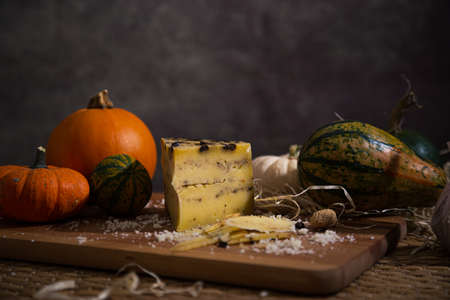 different slicing cheeses Handmade cheese on a wooden board delicious treats foodfotos foodphotoの写真素材