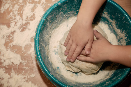 Woman sculpts homemade dumplings bear ears in the kitchen. Modeling dumplings closeup. Female hands...
