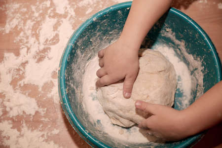 Woman sculpts homemade dumplings bear ears in the kitchen. Modeling dumplings closeup. Female hands sculpt dumplings.の写真素材