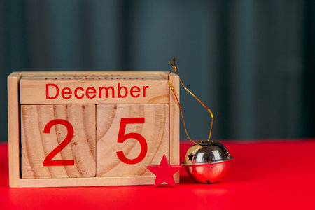 Photo of a wooden calendar on a red background, christmas, wooden toys, place for text