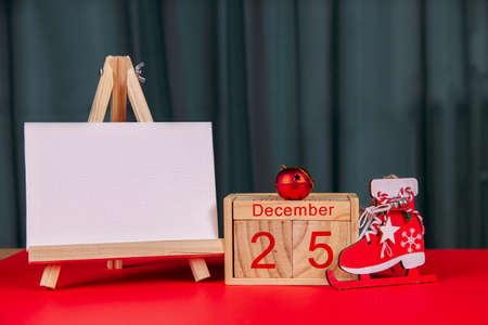 Photo of a wooden calendar on a red background, christmas, wooden toys, place for textの写真素材