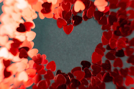 Scattering of small red hearts, beautiful background of hearts for the holiday of valentineの写真素材