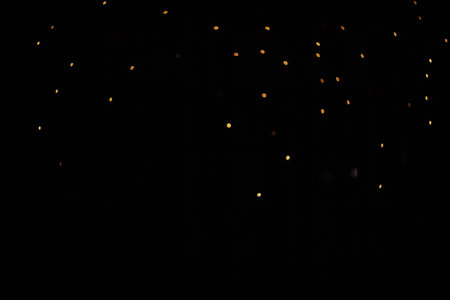Beautiful golden bokeh on a black background, bright lightsの写真素材
