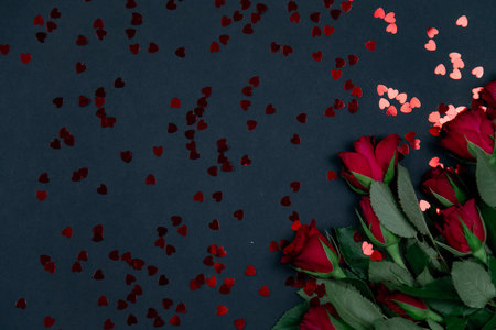 Red roses for the holiday on a dark background, valentine's day, march 8, beautiful card with rosesの写真素材