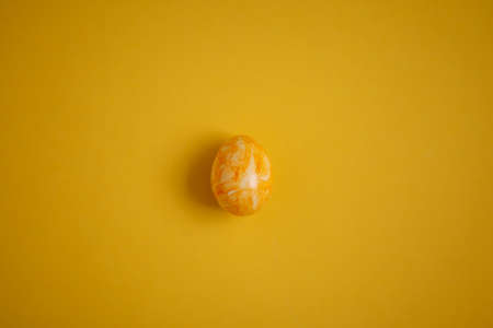 yellow easter eggs on yellow background, top view, place for textの写真素材