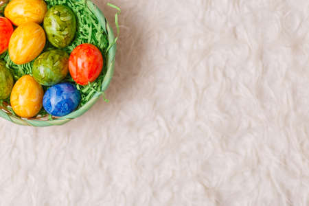 Easter card. Flat lay composition with easter eggs in a basket on white background. Top viewの写真素材