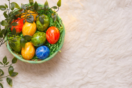 Easter card. Flat lay composition with easter eggs in a basket on white background. Top view