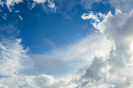 Blue sky background with white clouds. Cumulus white clouds in the blue sky.