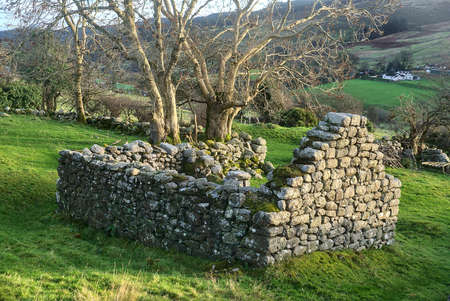 Ruins of small stone old building along the road near the Glendoo Mountain, County Dublin, Ireland. Historical ruinsの写真素材