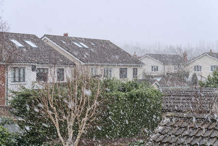Beautiful heavy snowfall in Ballinteer,Southern Dublin, Ireland. Viewed form the window during coronavirus lockdown. Unusual Irish winter 2021. Traditional housesの写真素材