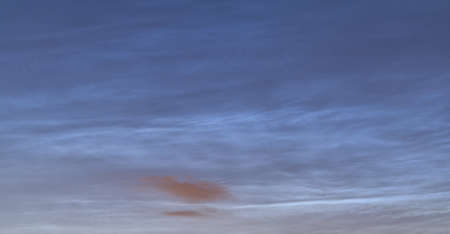 Beautiful panoramic view of very rare noctilucent clouds and stars shining through them seen in Dublin, Ireland on summer solstice of 2021 before midnight. Details of NLC. Night shining panoramaの写真素材