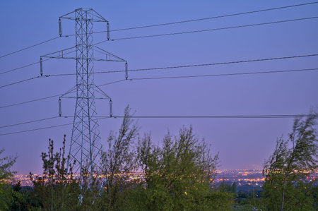 Beautiful early morning view of power lines with electricity transmission pylon against epic sky...