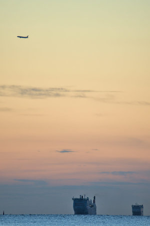 Beautiful early morning view of two sea truck ferry ships in Irish Sea and airplane over Howth seen...