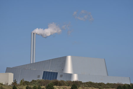 Beautiful closeup bright view of Covanta Plant (Dublin Waste to Energy) against clear blue sky seen from Sandymount Beach, Dublin, Ireland. Poolbeg Incinerator.の写真素材