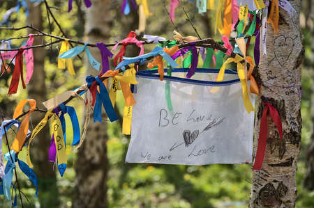 Be Love, We Are Love. Beautiful closeup view of many ribbons of different colors tied on branches of spring birch tree seen at university campus, Dublin, Ireland. Soft and selective focusの写真素材