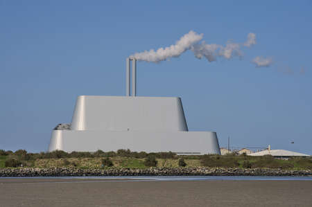 Beautiful closeup bright view of Covanta Plant (Dublin Waste to Energy) against clear blue sky seen from Sandymount Beach, Dublin, Ireland. Poolbeg Incinerator.の写真素材