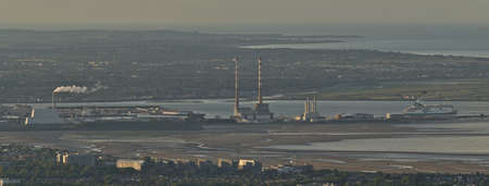 Dublin, Ireland - June 11, 2021: Beautiful aerial panorama of Poolbeg CCGT chimneys, Pigeon House Power Station and Irish Ferries seen from Ticknock. Industrial cityscape. Soft and selective focusのeditorial素材