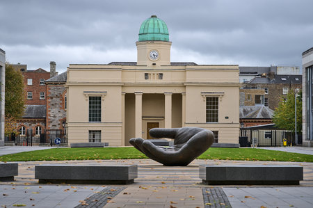Dublin, Ireland - October 23, 2021: Beautiful autumn view of The Clock Tower building and The Wishing Hand sculpture at courtyard of Department of Educationのeditorial素材